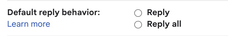 Screenshot of a Gmail settings interface displaying "Default reply behavior:" with unselected radio button options for "Reply" and "Reply all", followed by a blue "Learn more" link.